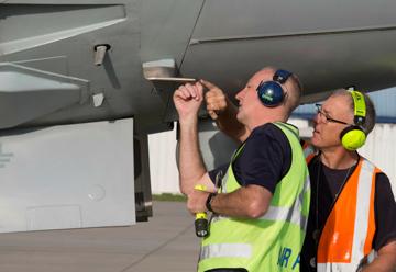 Two people inspecting an aircraft