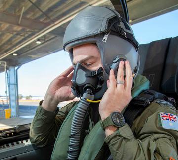 Person (Pilot) wearing helmet and oxygen mask